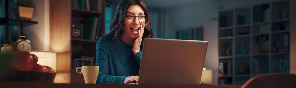 Happy young woman at her computer